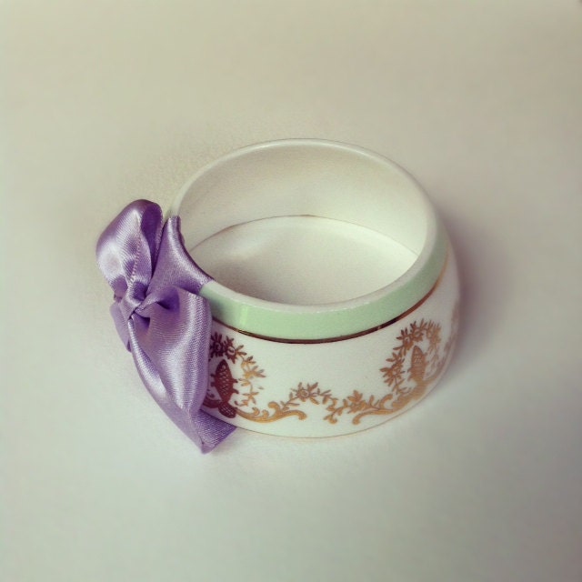 StayGoldMaryRose - Beautiful gold regal crest pattern tea cup bracelet with light pastel lavender hand mane satin bow.