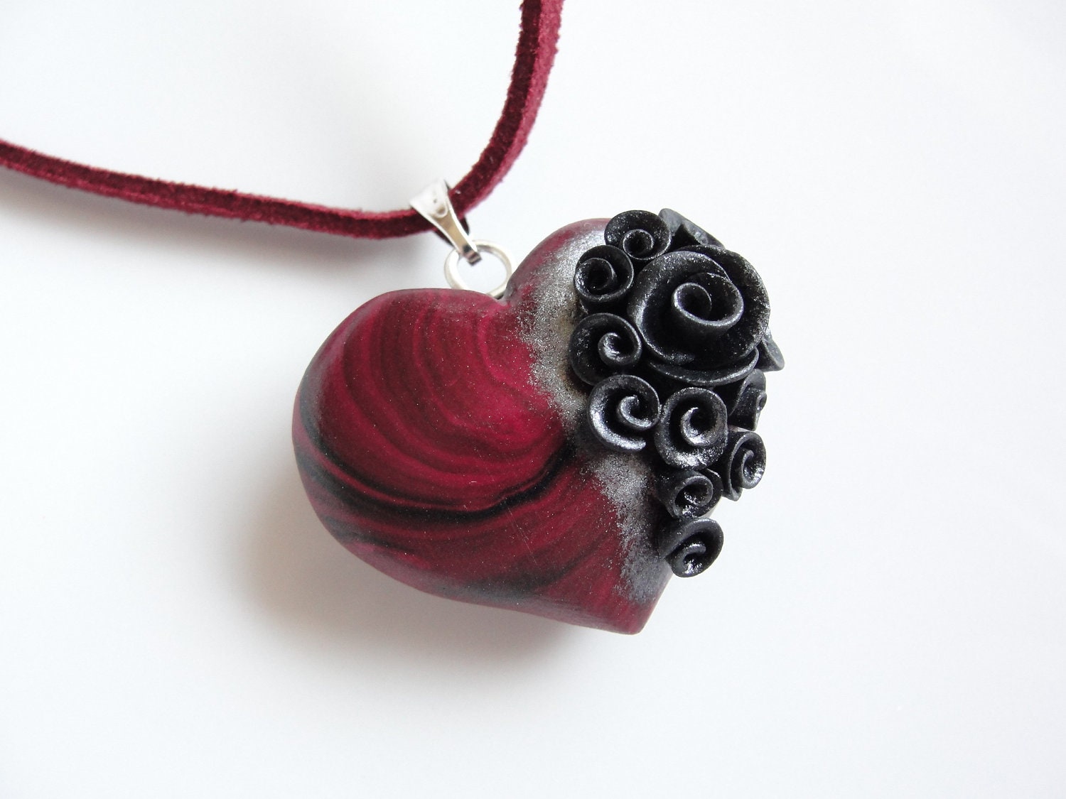 Swirly red and black heart pendant with black and silver roses on faux suede cord necklace
