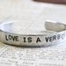 Bracelet Hand Stamped Love Is A Verb Cuff Aluminum Can Be Personalized With Your Own Words