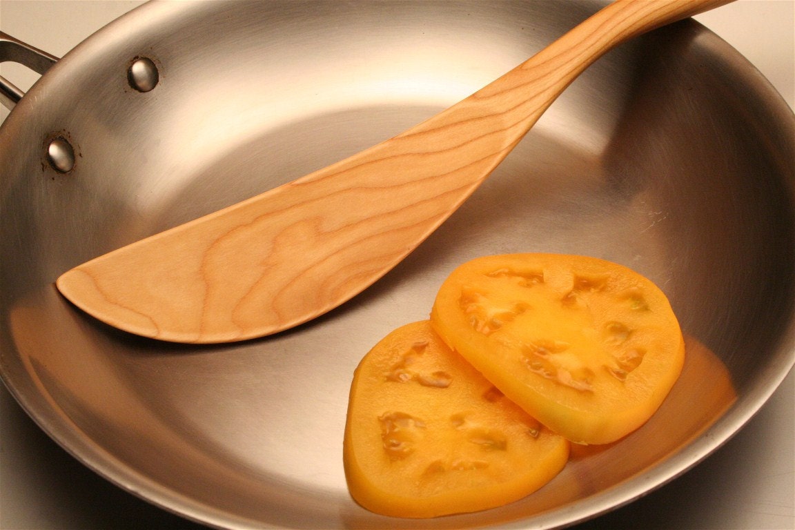 wooden saute spatula carved with an ergonomic handle