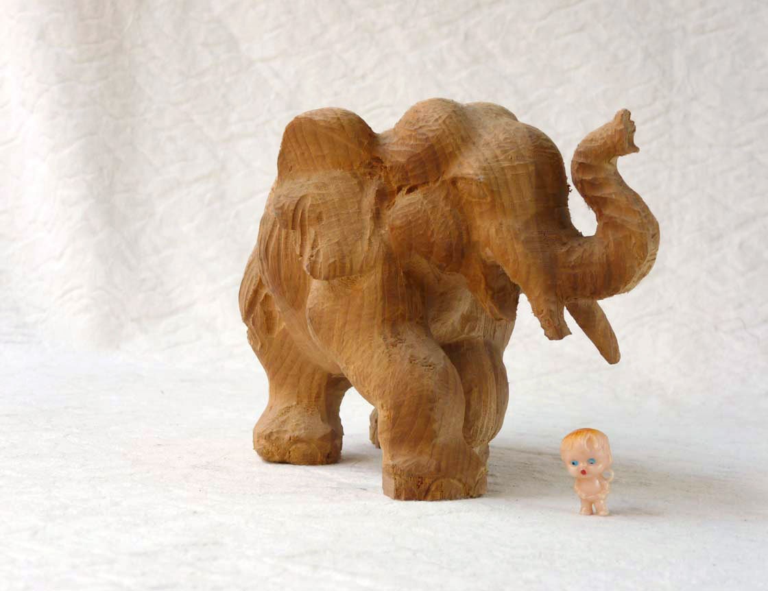 Carved Wooden elephant, trunk up, laughing pachyderm