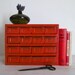 vintage industrial cherry red metal storage cabinet with 16 drawers