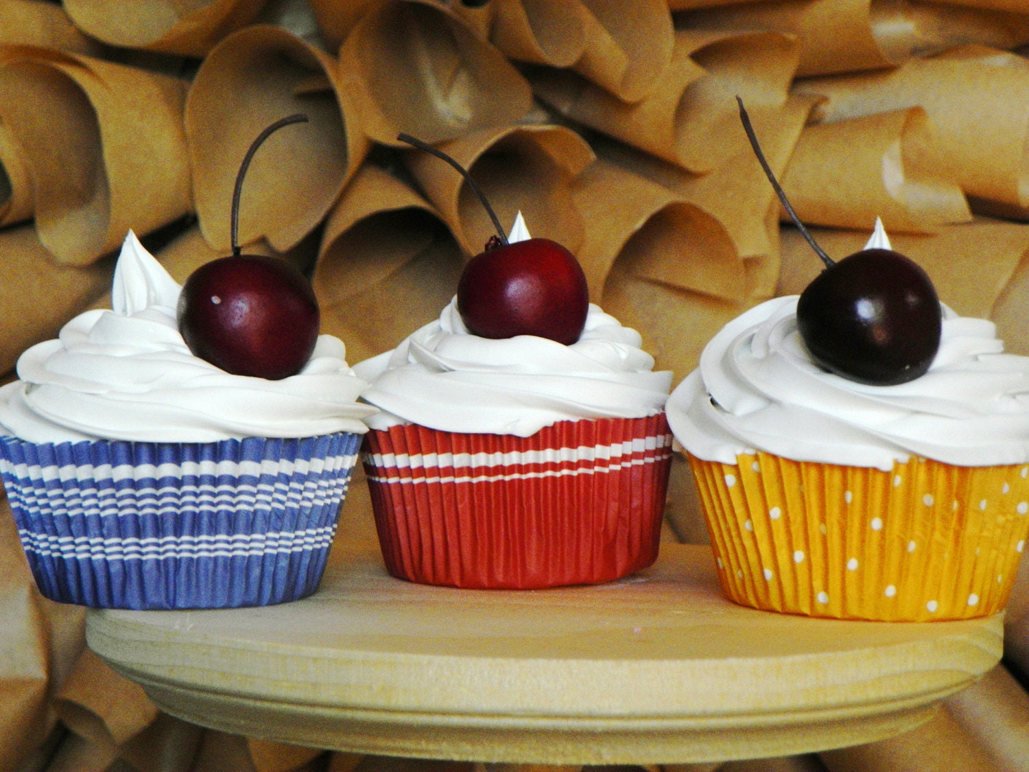 fake country cupcake trio, Primary colors, 3 white frosting cupcakes,with a cherry topper