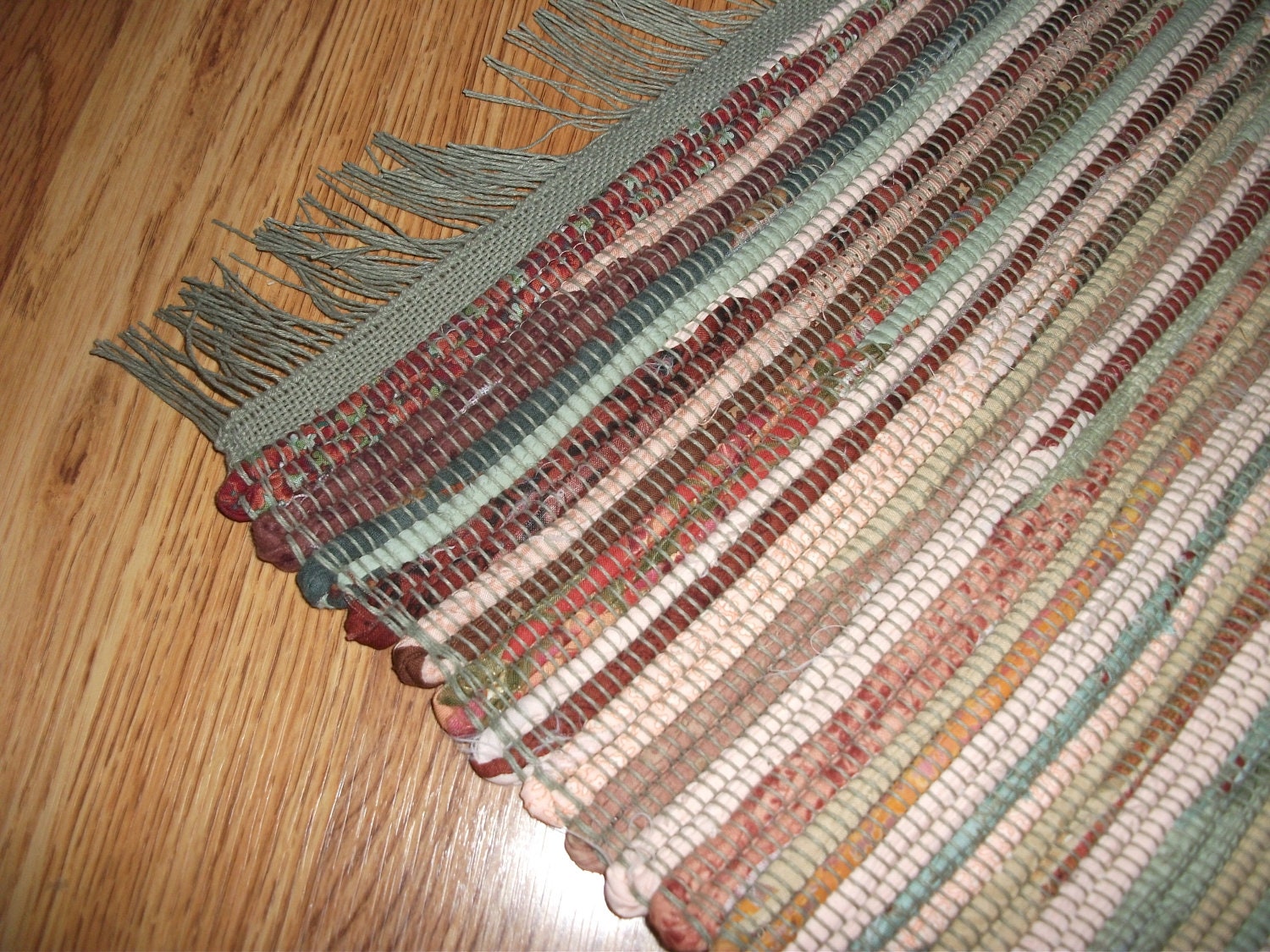 Handwoven cotton rag rug in shades of sage green by ozarkloom