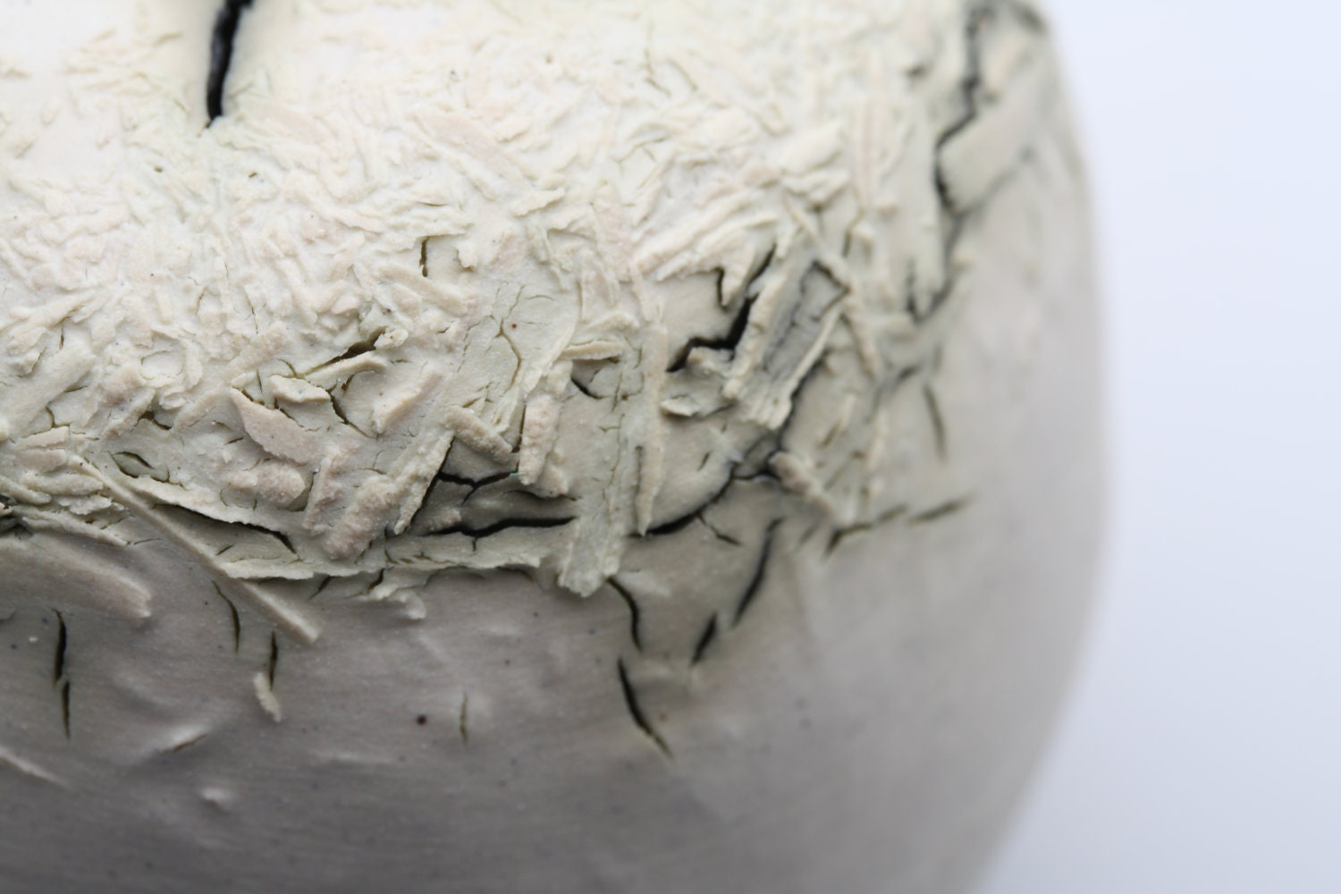 Stoneware decorative sphere vessel with white clay & copper oxide.