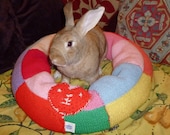big plump Ugli Donut bunny rabbit bed for a giant sized bunny hand knit bright colours