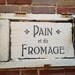 Pain et du Fromage sign painted on old wooden door panel