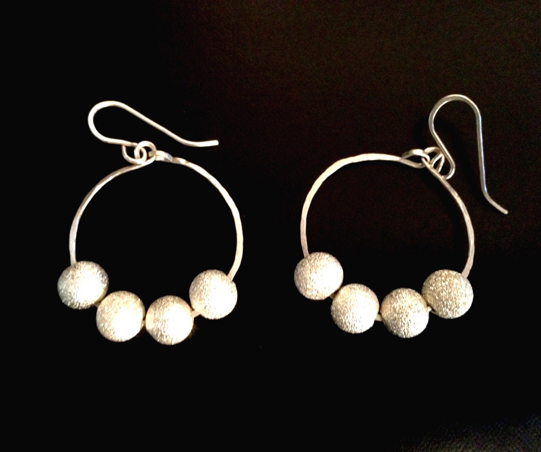 Hoop sterling silver earrings. Light weighted, with white shiny  sparkly  beads. Designed in Fashion Brand Faina Studio.