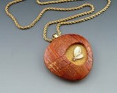 Contemporary asymmetric pendant with leaf detail on heavy rope chain