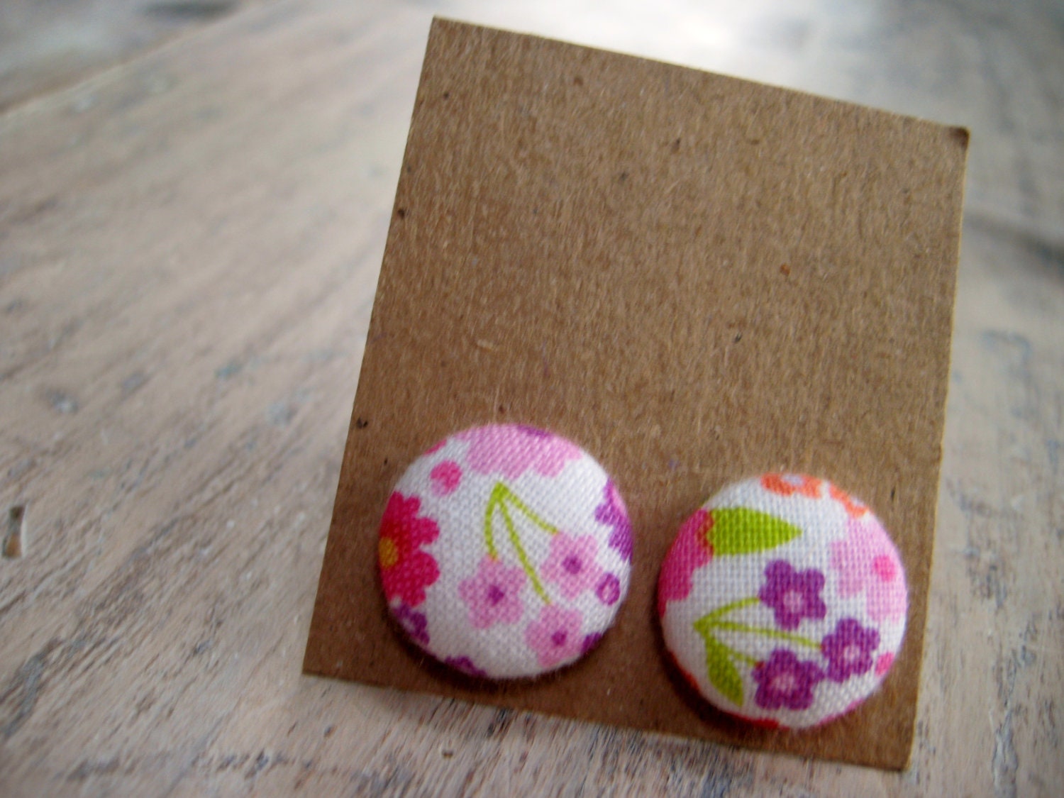 button earrings - pink and purple flowers with green leaves on white - pattern placement varies