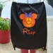 Trick or treat in style with this adorable Mickey or Minnie tote bag