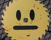 Straight-faced emoticon blood splattered saw blade original art