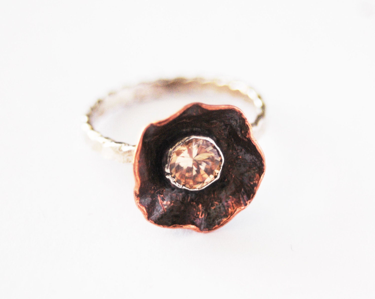 Handformed Copper Wild Flower ring adorned with a 6mm peach champagne cz and sterling silver twisted band