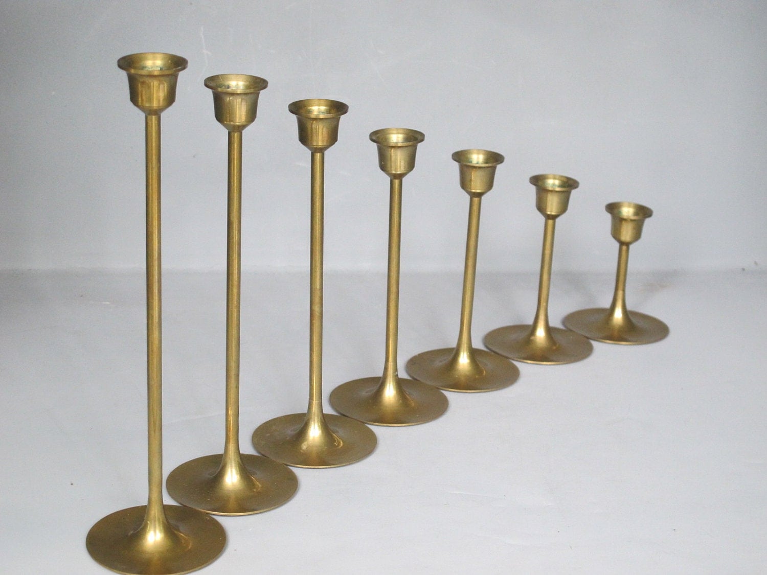 Vintage Set of 7 Brass Candle Holders / Sleek by MilkaCervenka