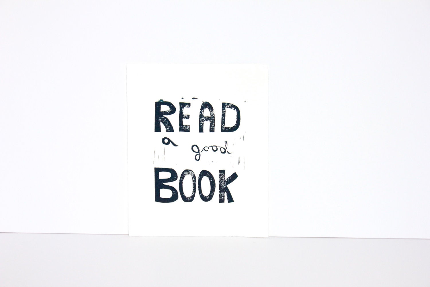 Typography print of Read a Good Book Linocut in black 8x10 on white paper