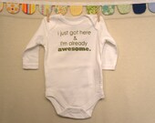 I just got here & I'm already awesome.  --- white long-sleeved onesie, size 0-3 months.