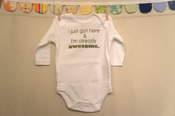 I just got here & I'm already awesome.  --- white long-sleeved onesie, size 0-3 months.