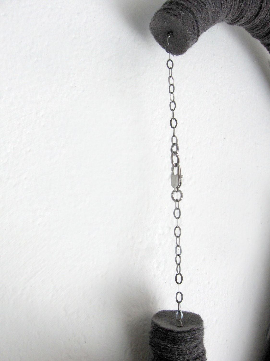 grey tube minimal geometric necklace with an arc ceramic bead and a red touch