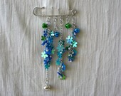 silvertone  brooch ,kilt pin -  shade of blue flower beads with bells.