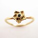 Slender 14 carat flower ring with blue topaz