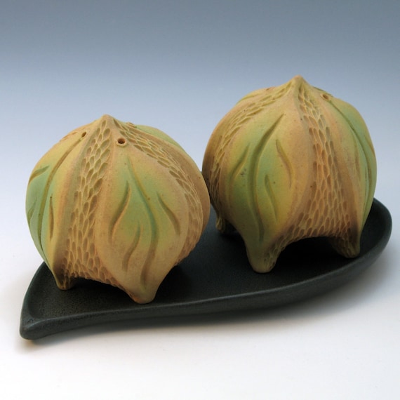 Hand carved tan and green salt & pepper shakers with leaves