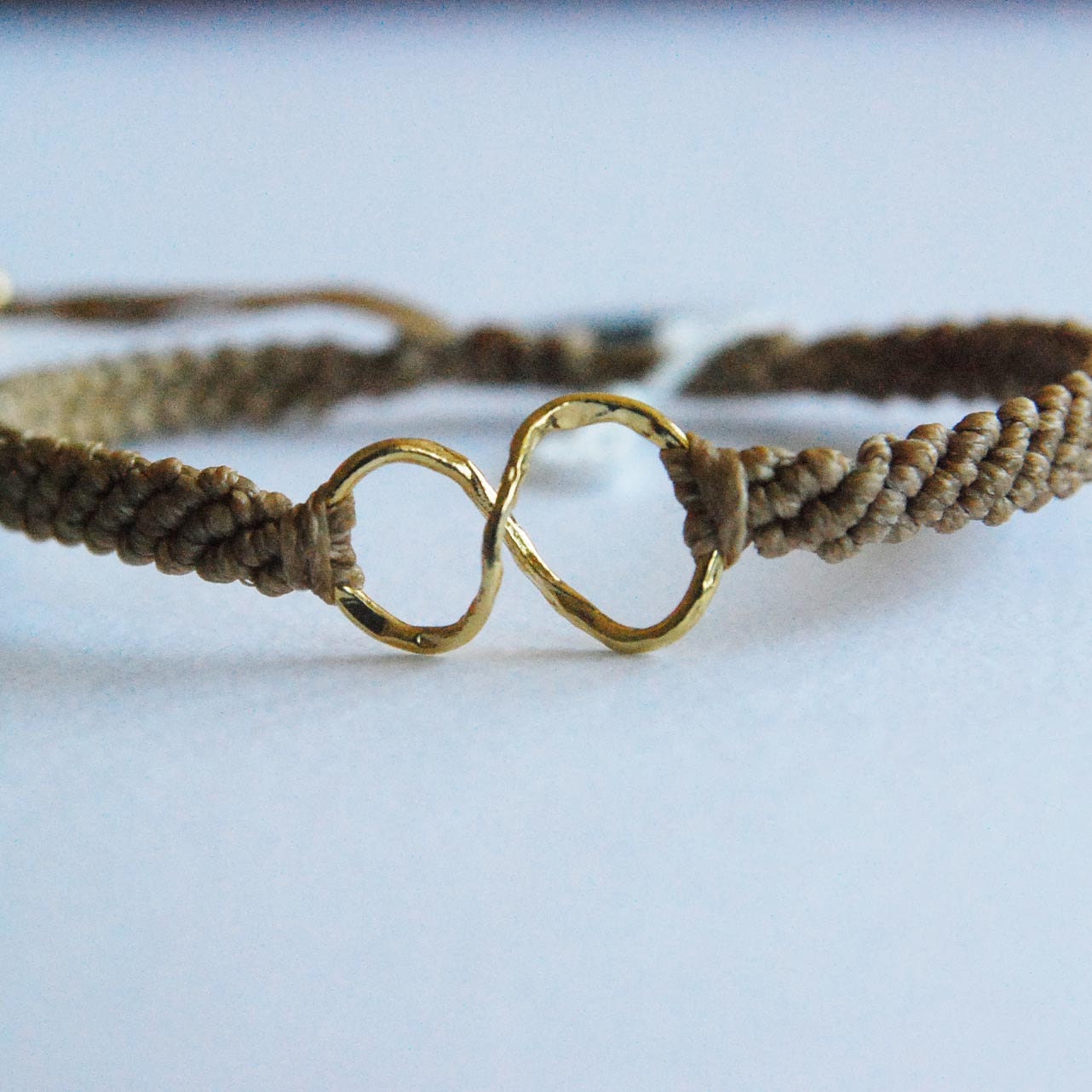 Gold infinity symbol bracelet, beige cord