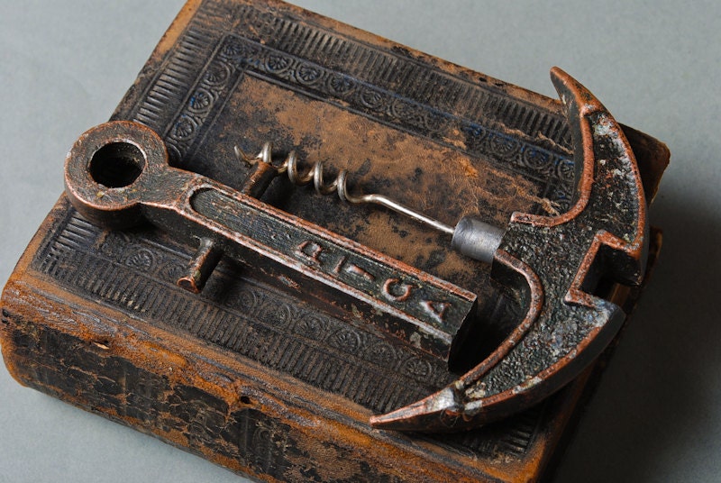 Vintage metal corkscrew stylized as anchor. Bottle opener.