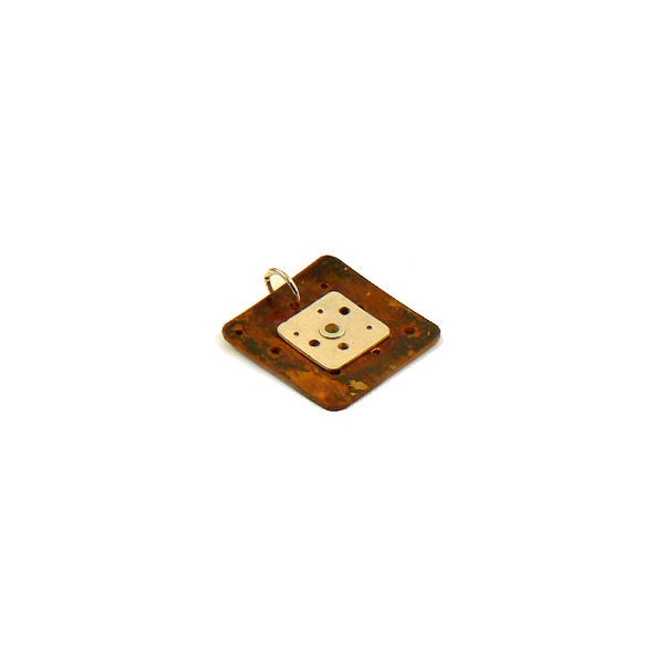 Silver and copper riveted pendant