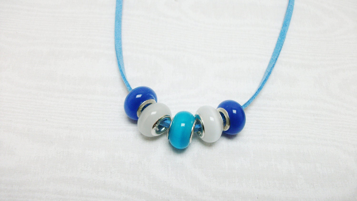 cat's eye large hole beads 925 inserts blue aqua white on light blue suade