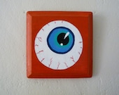 Blue and Red Eyeball Painting On Wooden Square
