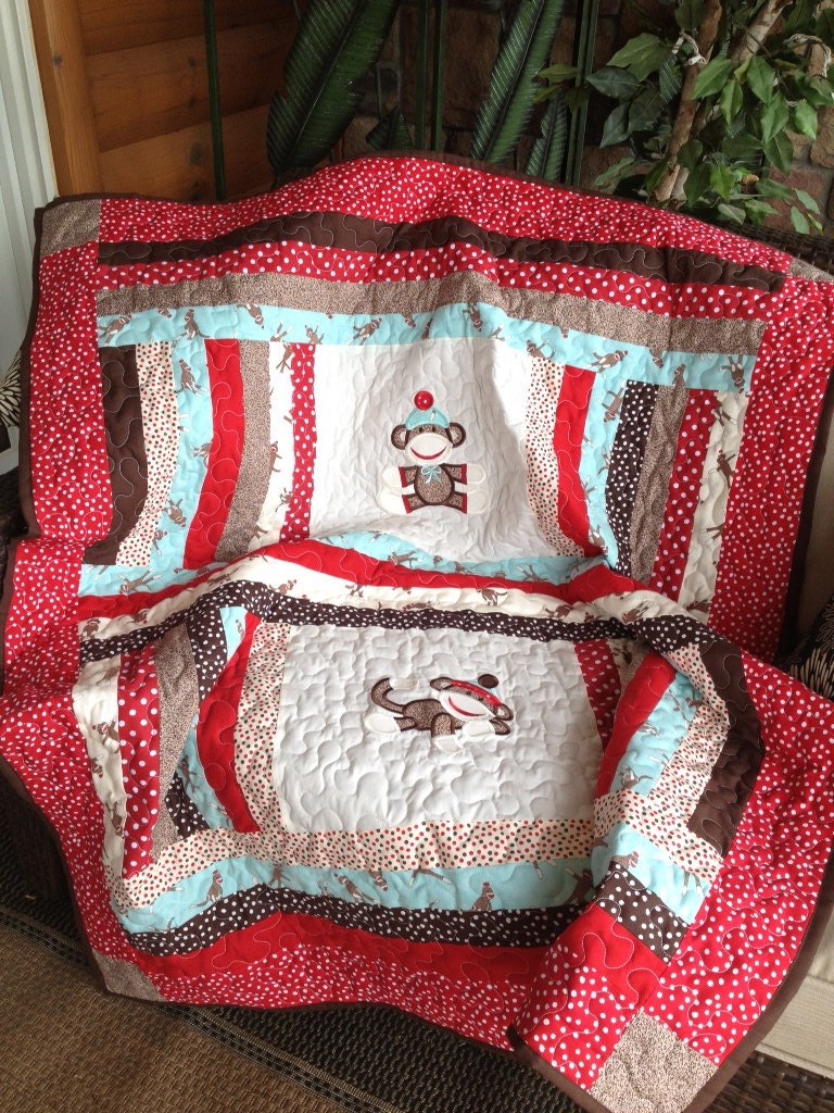 Blue, red, brown, and cream boy sock monkey baby quilt approx. 50x58