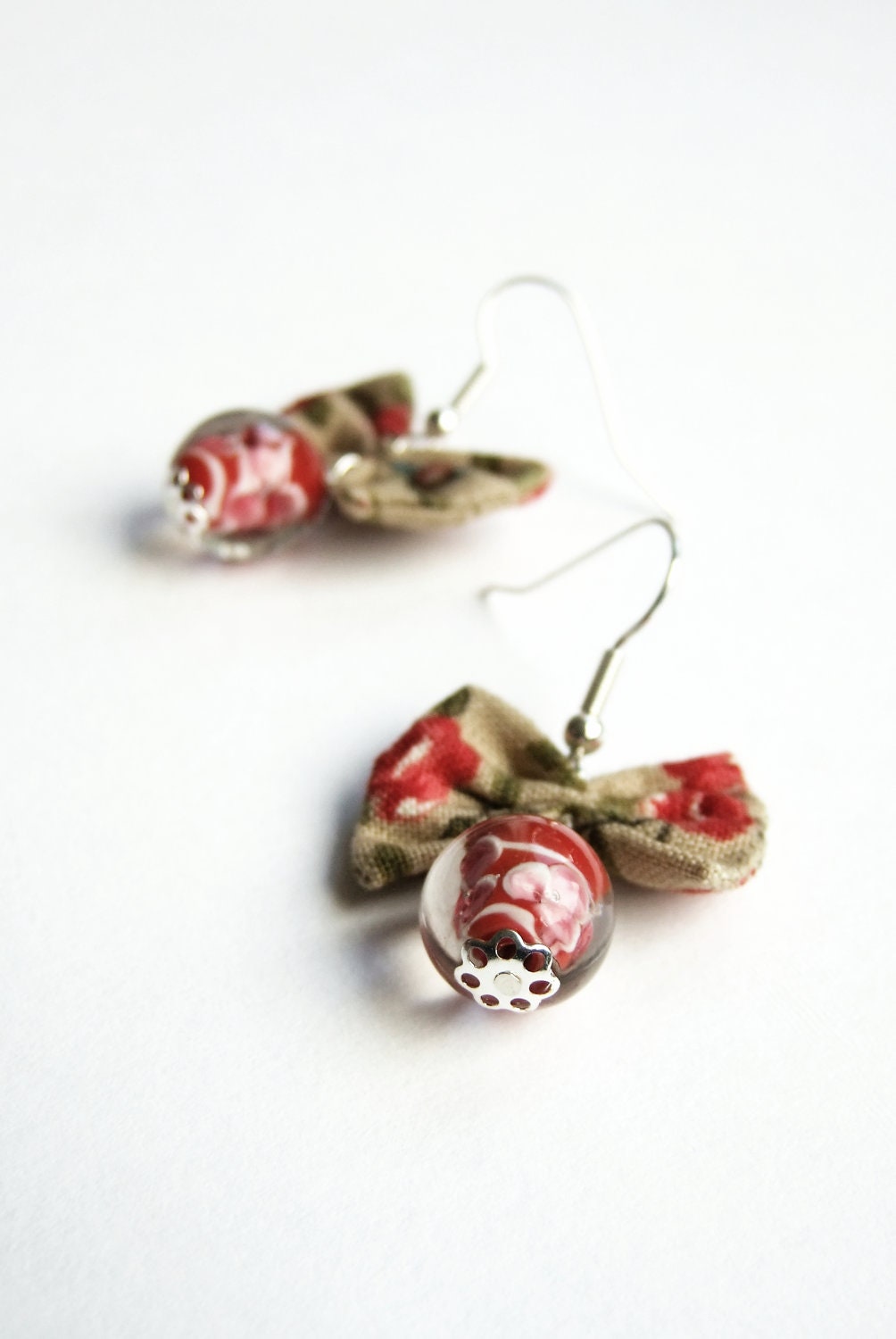Tan and red fabric bow and red glass lampwork bead earrings