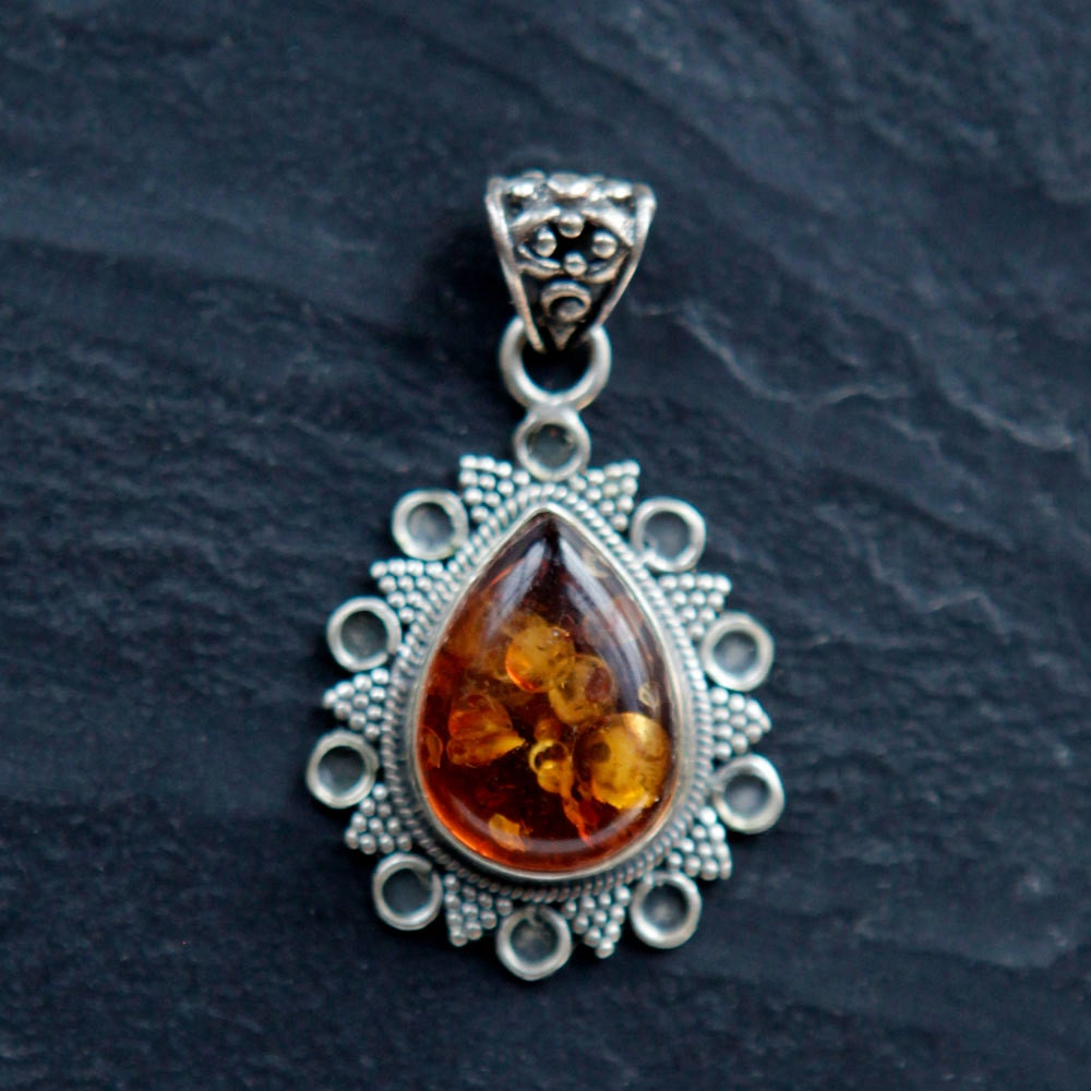amber pendant. perfect centerpiece for hemp, or alone on a chain. .925 sterling