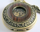 Wooden cover open movement style pocket watch or necklace. Brass colored chain and key charm