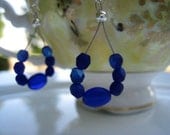 Dark blue Frosted Swarovski Crystal beads and oval blue glass beads on Accuflex wire teardrop  dangle earrings