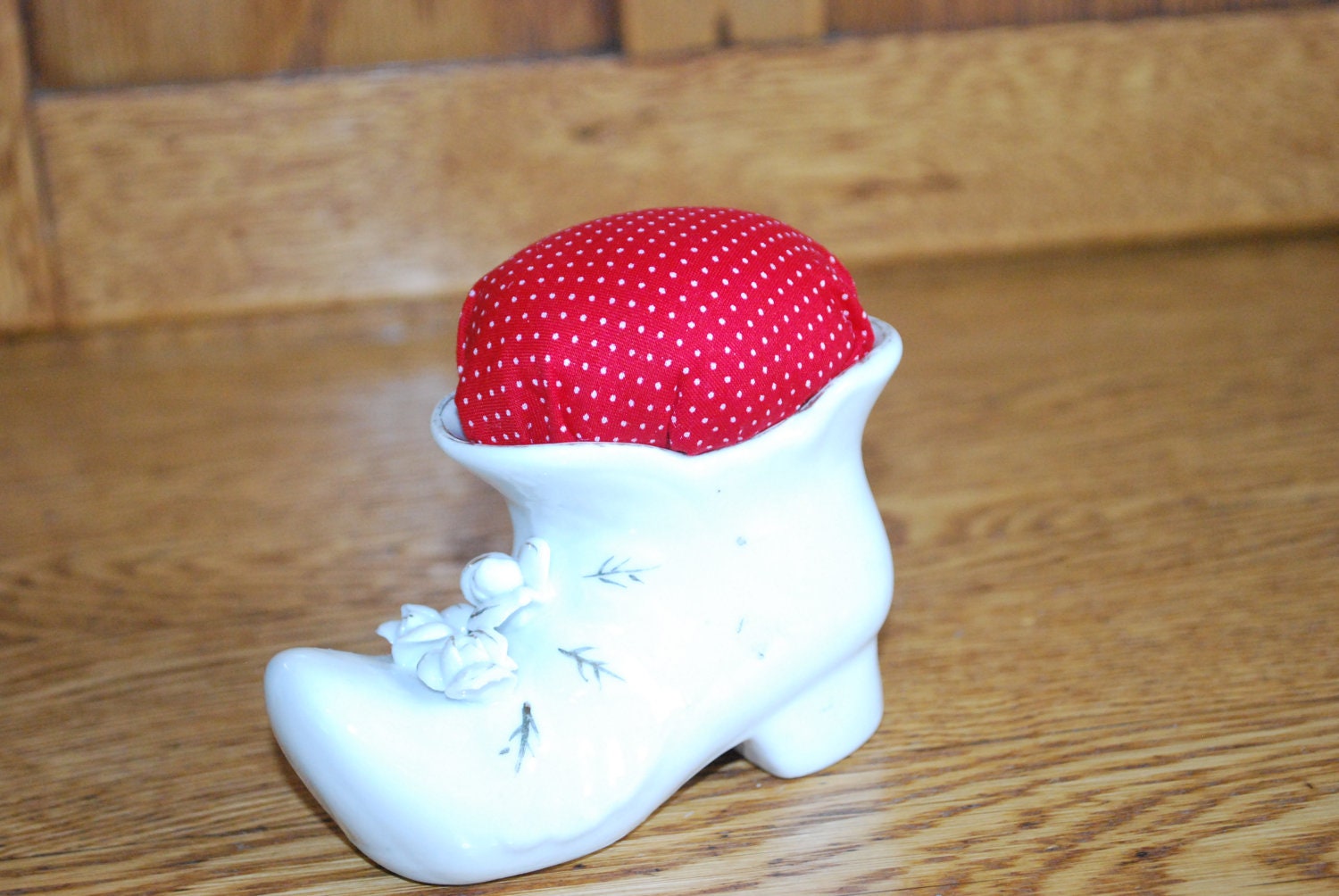 White ceramic shoe planter, re purposed into a pincushion.