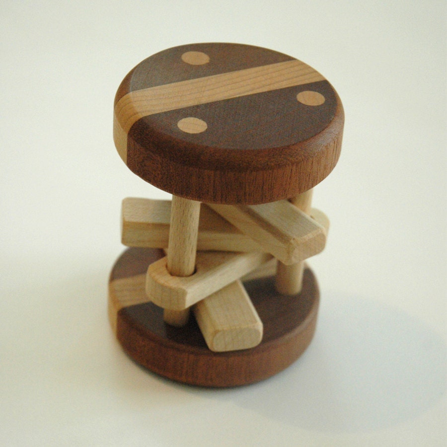 Wooden rolling rattle made of three types of natural wood