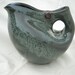 Altered blue pitcher