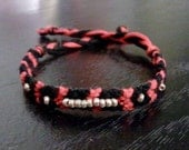 Red and black friendship bracelet with gold beads