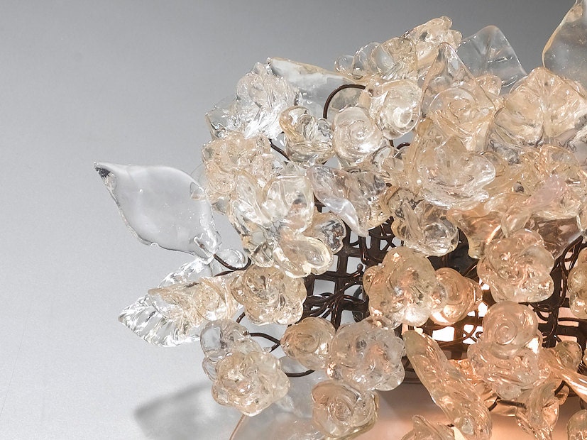 Wall light fixture. Transparent flowers and leaves.