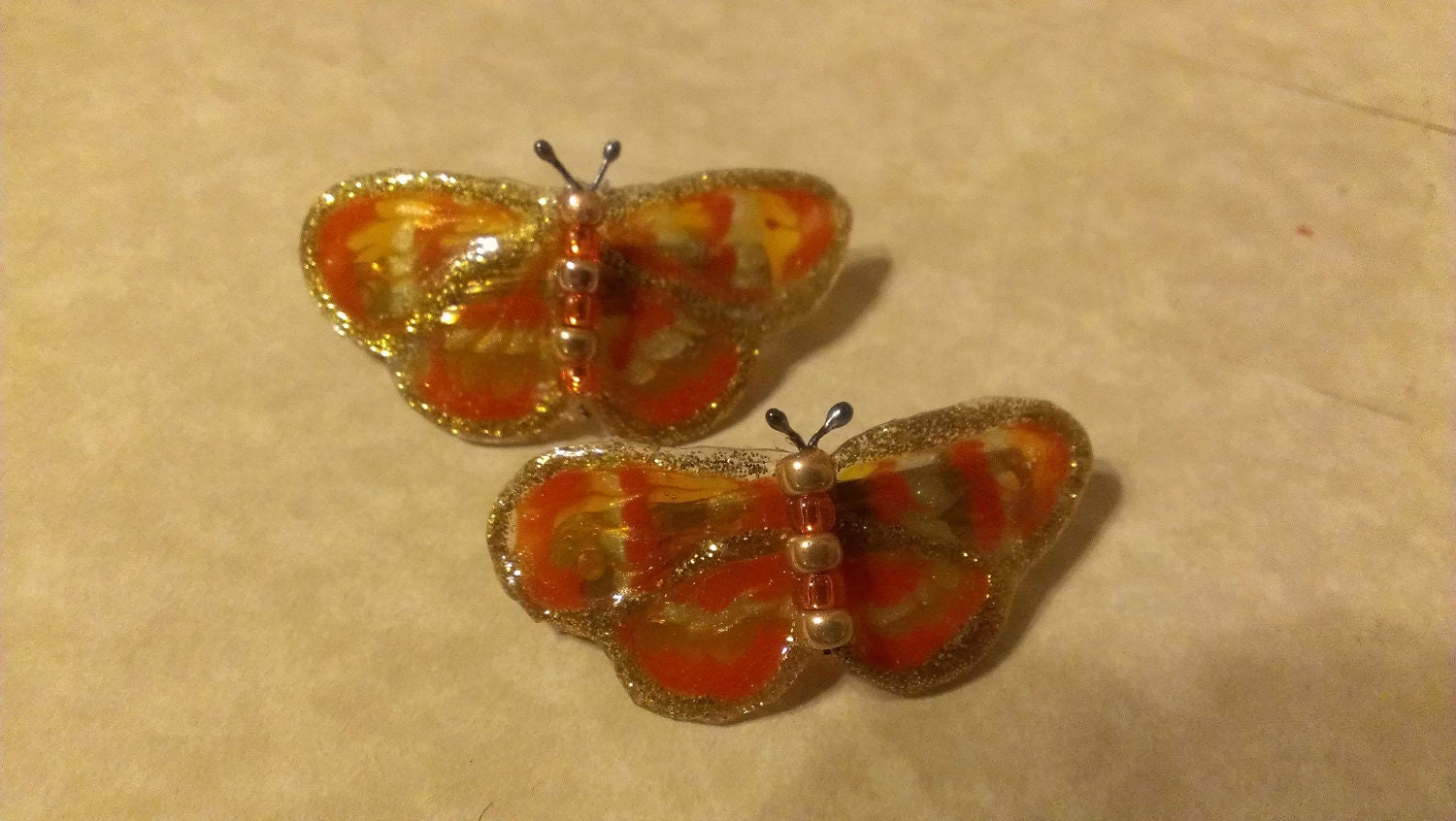 pair of mini orange butterfly barrettes