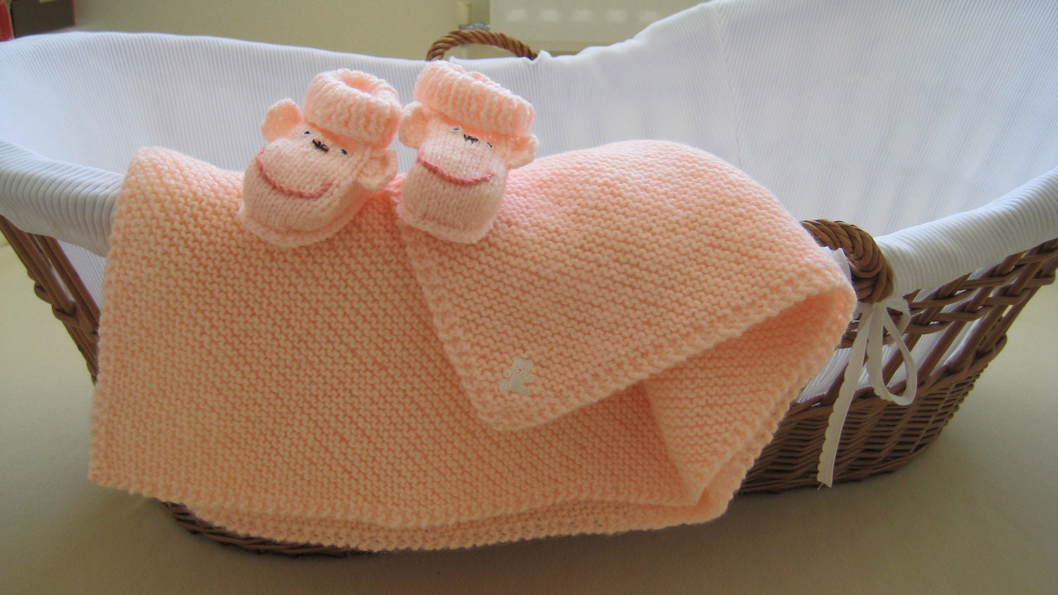 Knitted Baby Blanket: Apricot baby blanket with matching Cheeky Monkey baby booties.