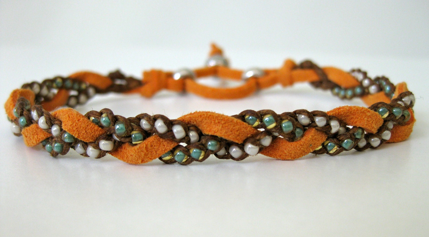 Orange, pearl, and turquoise woven bracelet