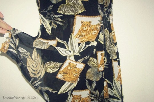 A novo African inspired midi length dress with lions and green stuff and shoulder pads