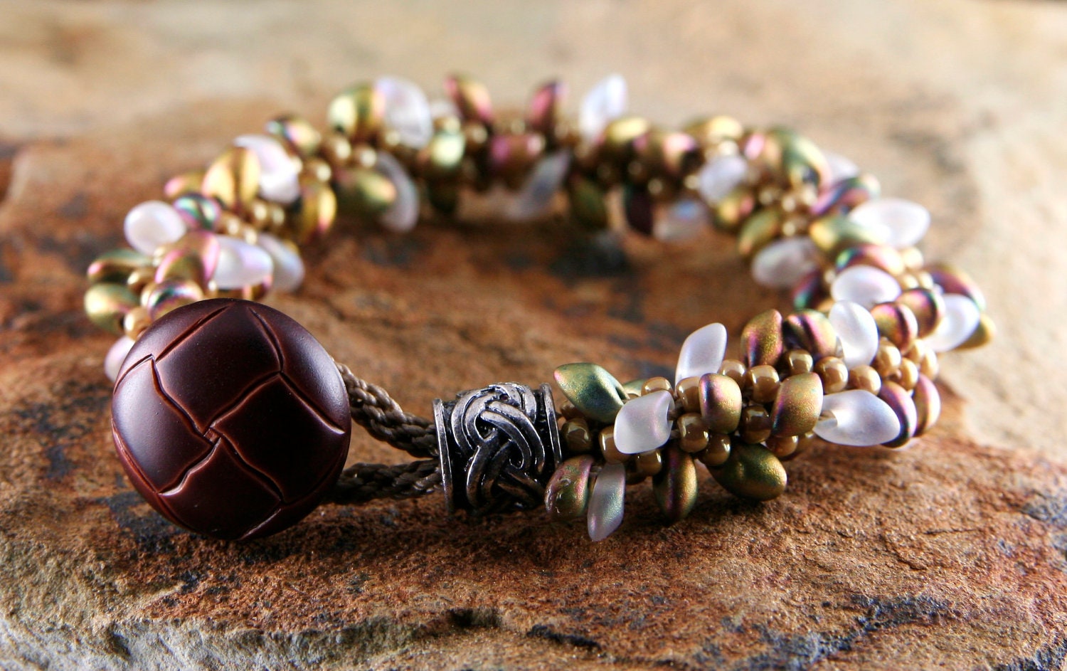 Distinctive bracelet, Iridescent Gold Kumihimo bracelet, braided Bracelet with Magatama beads and button closure by CAAZandeffect