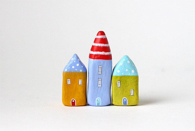 Little village with three clay houses with polka dots and stripes