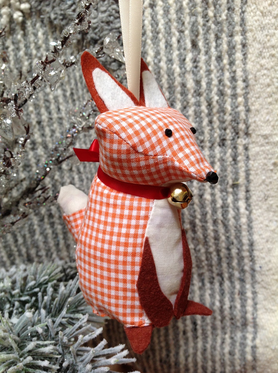 Small festive orange fox ornament with a Christmas bell