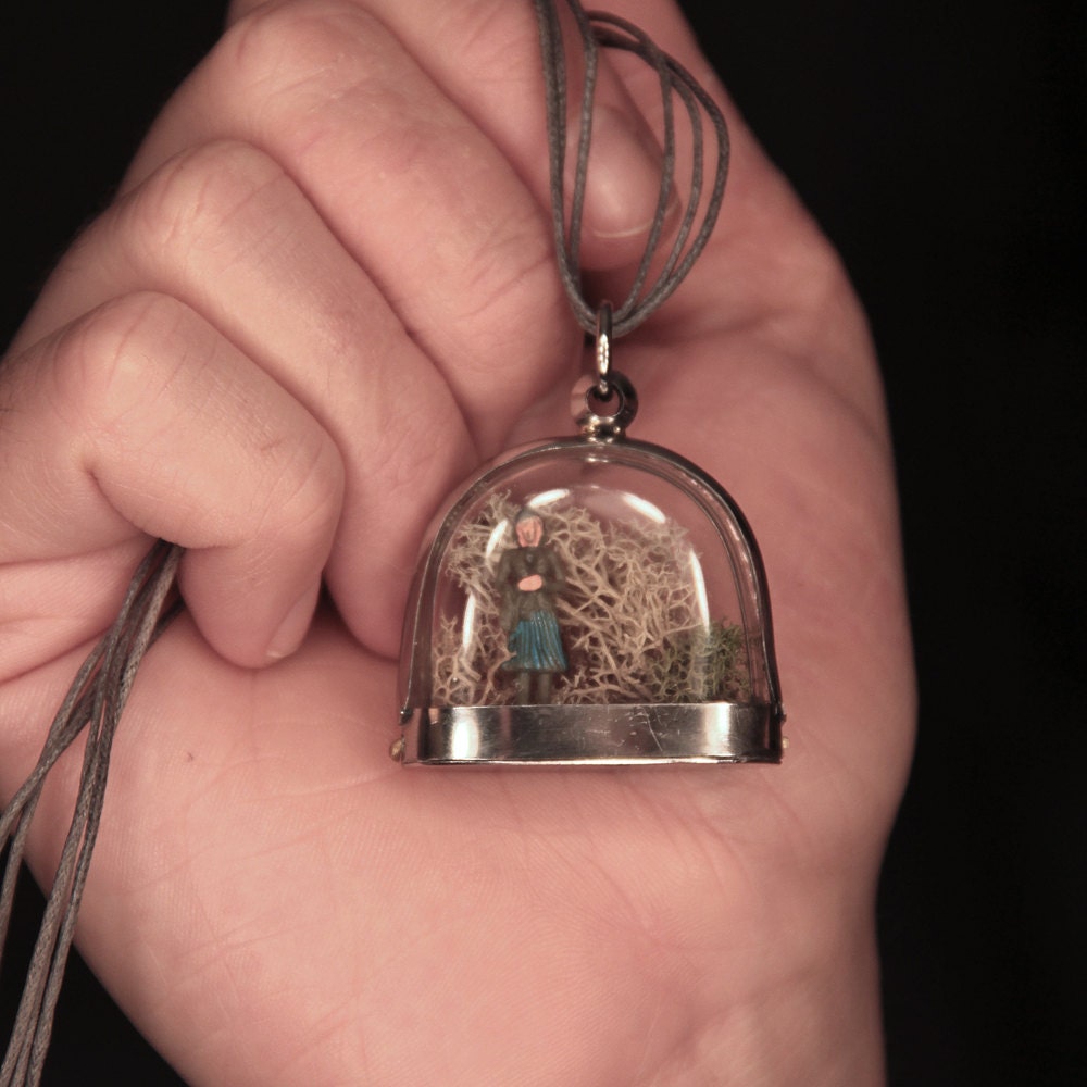 Miniature dome terrarium window locket with tiny standing person. Clear windows. Medium length necklace