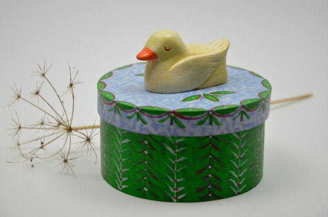 Round wooden trinket box with a sleeping duck on top