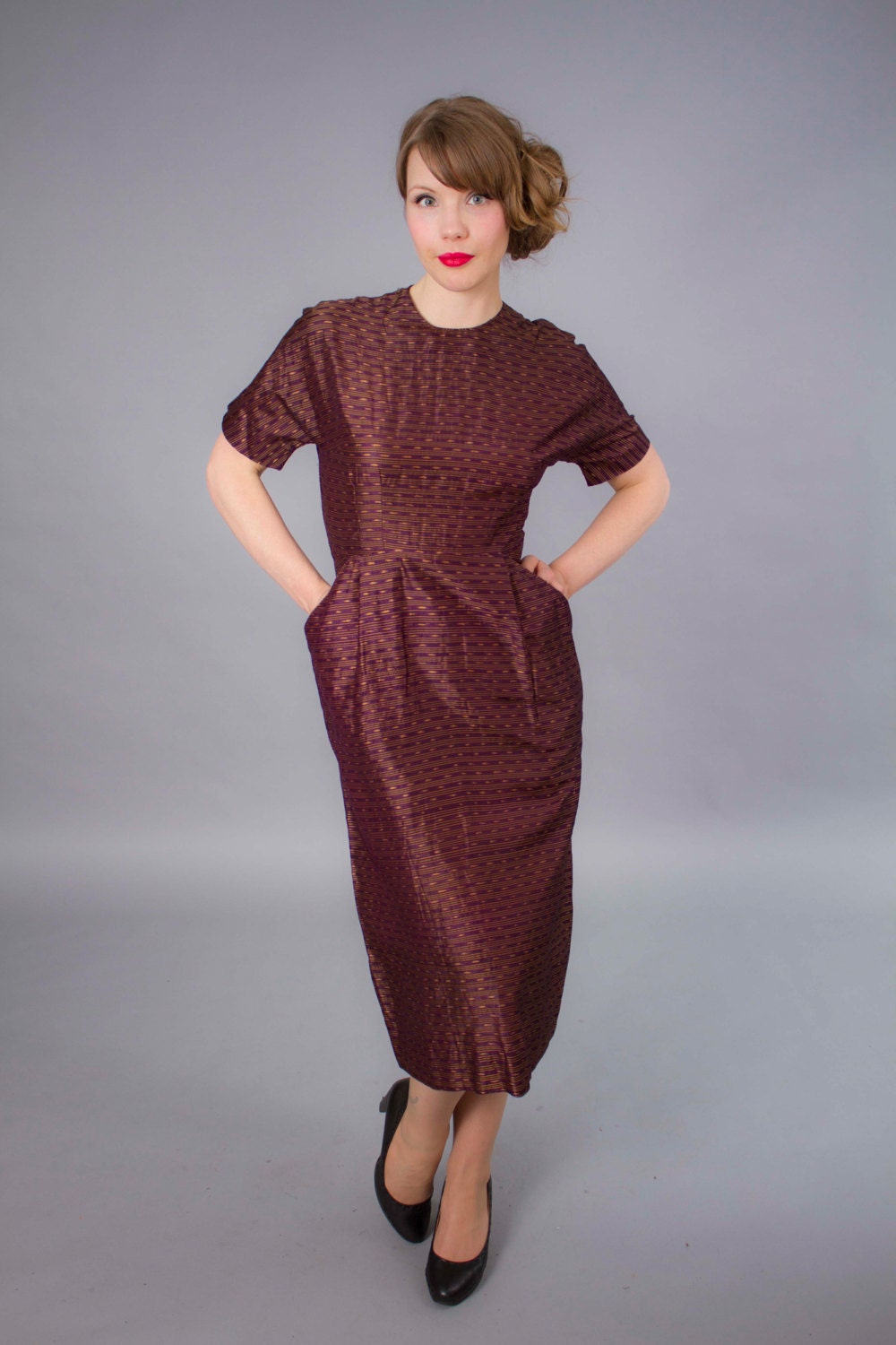 1940s dress . 40s eggplant purple and gold silk dress with pockets .
